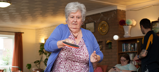 Older active woman playing ping pong