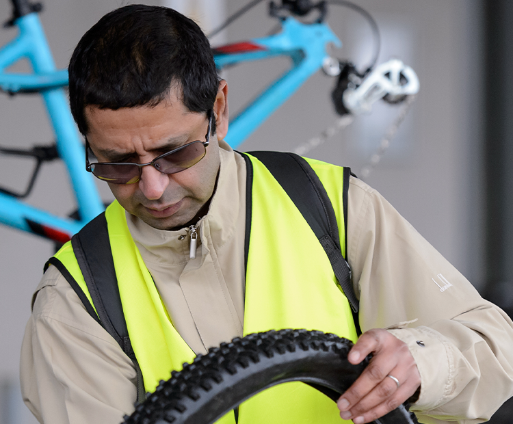 cycling volunteer fixes bike tire