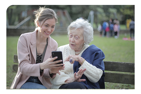 woman sharing phone with older woman