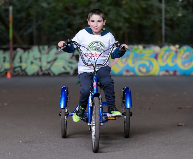 young boy on adapted bicycle