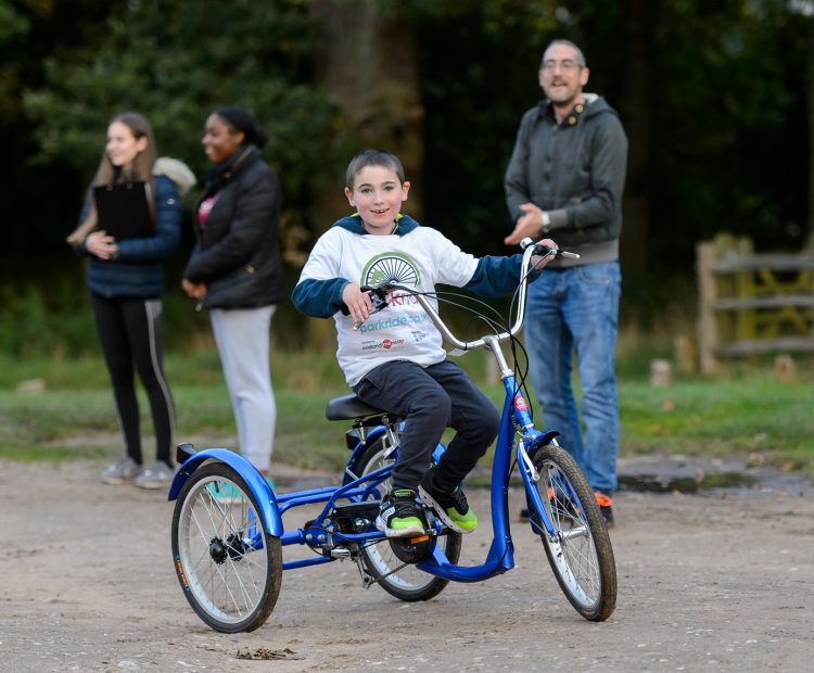 young disabled boy on adapted bicycle