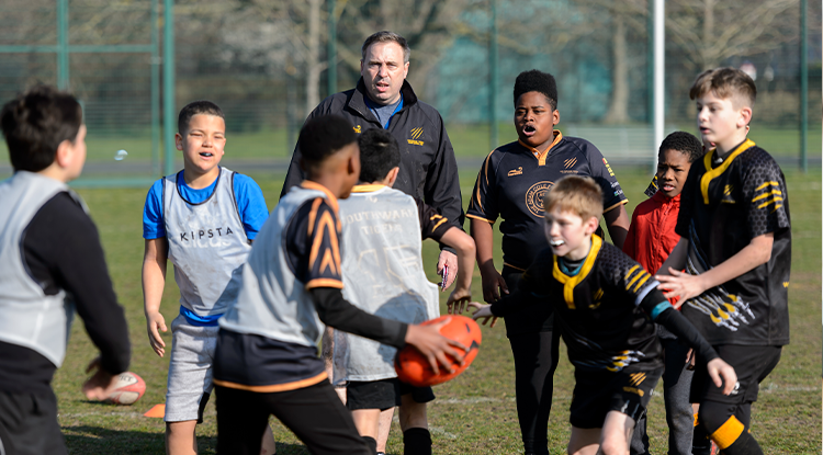 male coach with rugby boys