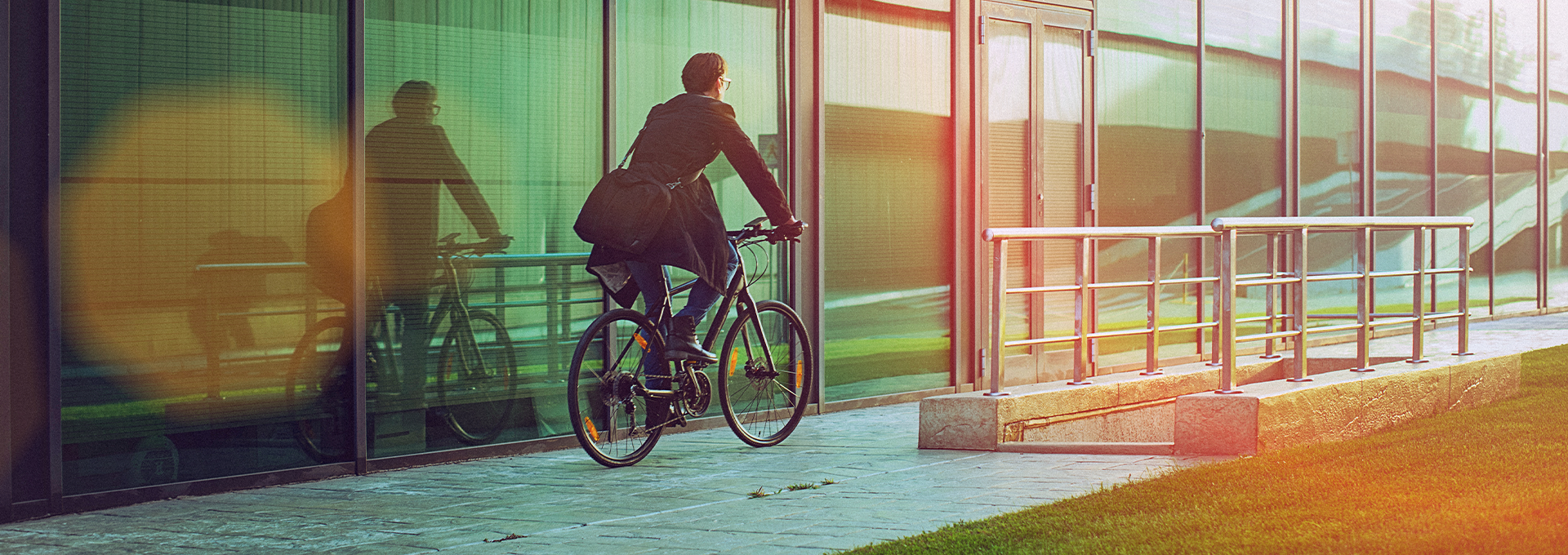 man cycling in front of office building